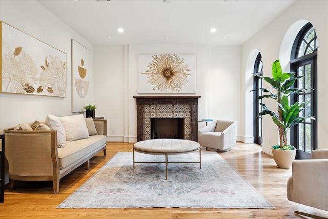 sitting room featuring a healthy amount of sunlight, light wood-style floors, a fireplace, and recessed lighting