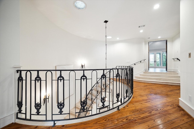 corridor with visible vents, an upstairs landing, wood-type flooring, french doors, and recessed lighting