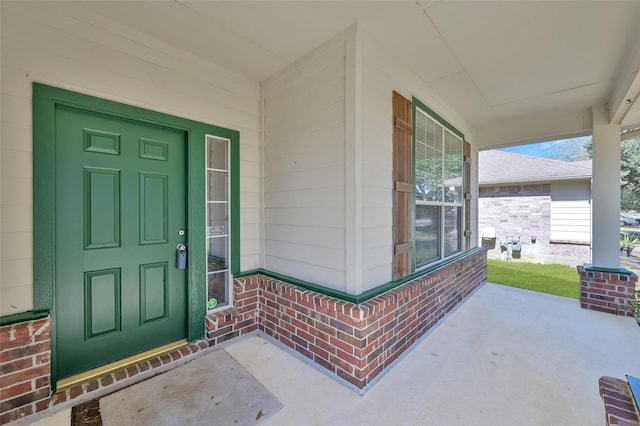 property entrance with brick siding