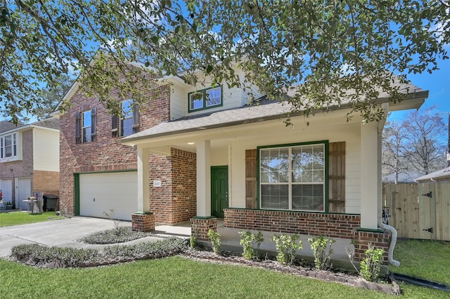 28807 Hidden Cove Dr, Magnolia, TX 77354 - traditional-style home with brick siding, a garage, driveway, and a porch