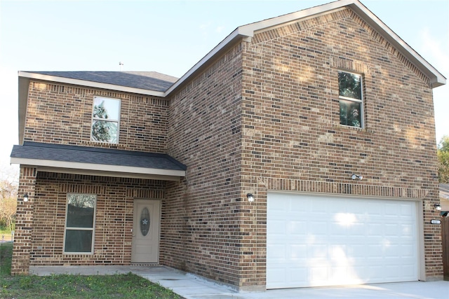 view of front of property featuring a garage, brick siding, and roof with shingles