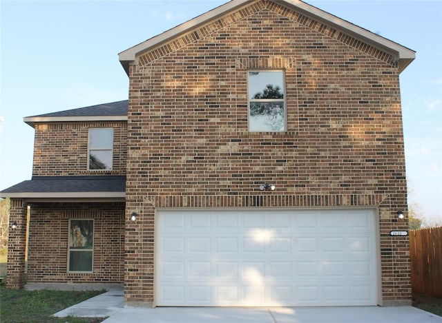 view of front of property featuring a garage, concrete driveway, brick siding, and roof with shingles