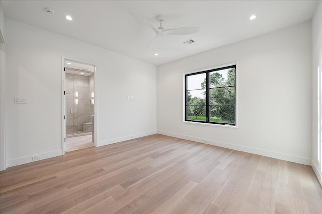 unfurnished room with light wood-type flooring, visible vents, ceiling fan, and baseboards