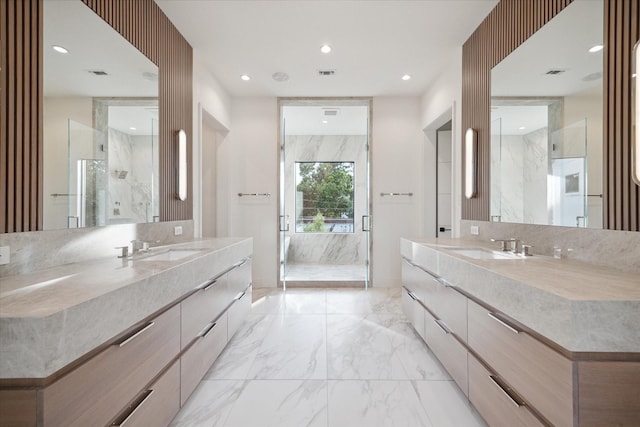 full bath featuring marble finish floor, a marble finish shower, visible vents, and a sink