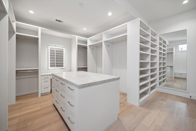 spacious closet featuring visible vents and light wood-style flooring