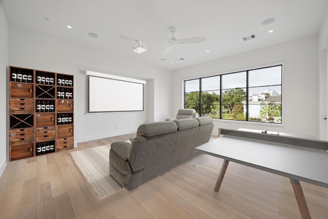 home theater room featuring ceiling fan, recessed lighting, visible vents, and light wood-style floors