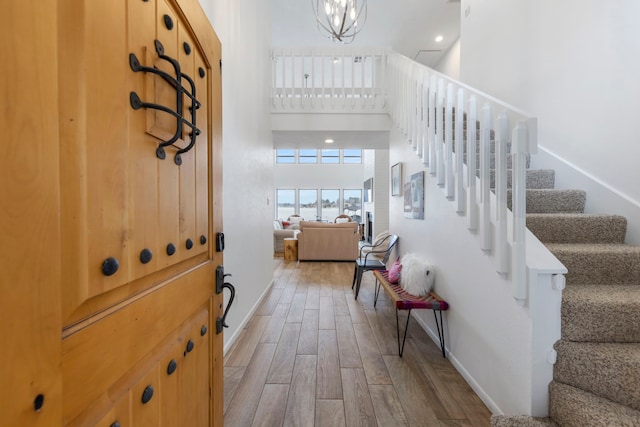 53 La Costa Dr, Montgomery, TX 77356 - foyer entrance with stairway, a towering ceiling, wood finished floors, a chandelier, and baseboards