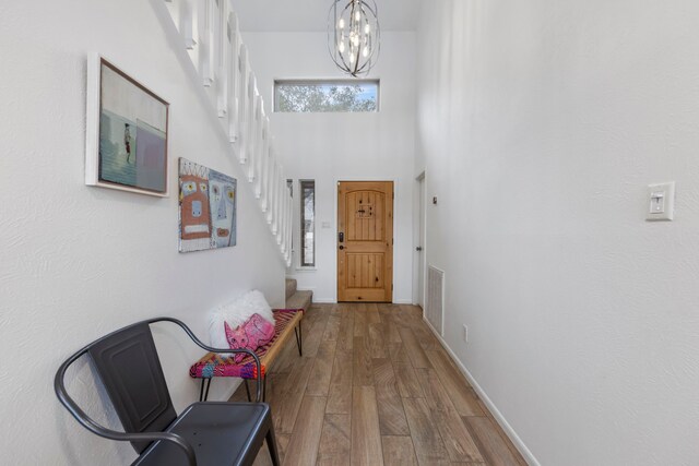53 La Costa Dr, Montgomery, TX 77356 - interior space featuring a notable chandelier, a high ceiling, wood finished floors, visible vents, and stairway