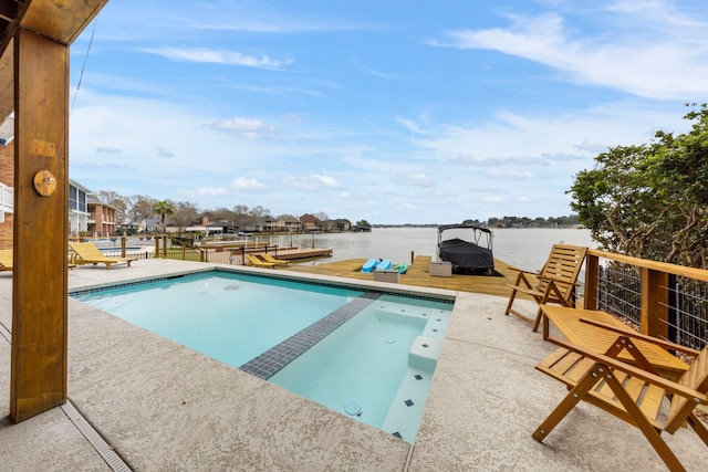 53 La Costa Dr, Montgomery, TX 77356 - view of pool featuring a boat dock, a water view, a pool with connected hot tub, and a patio