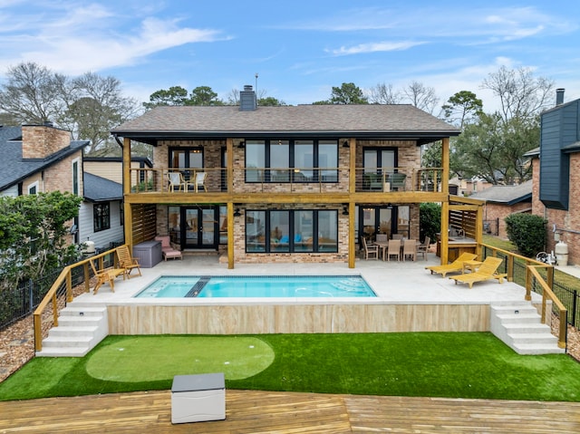 53 La Costa Dr, Montgomery, TX 77356 - back of house with a fenced in pool, a balcony, fence, a patio area, and brick siding