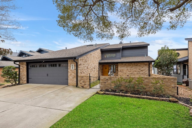 53 La Costa Dr, Montgomery, TX 77356 - view of front of house featuring brick siding, a gate, fence, a garage, and driveway