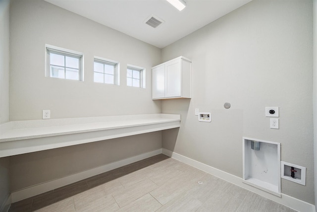 clothes washing area with cabinet space, visible vents, washer hookup, and hookup for an electric dryer