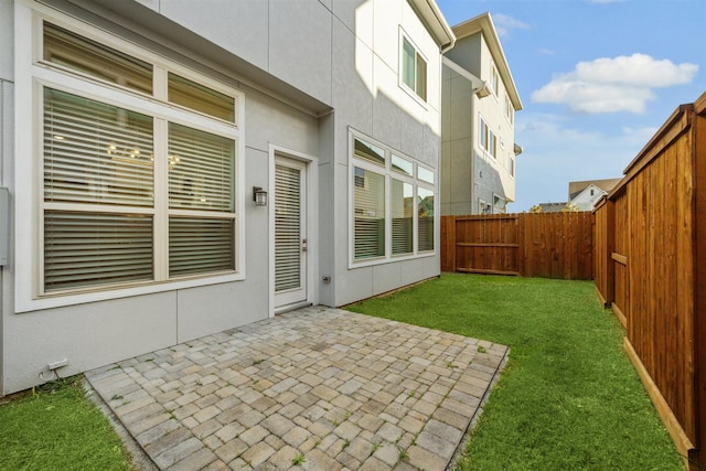 exterior space with a patio area and a fenced backyard