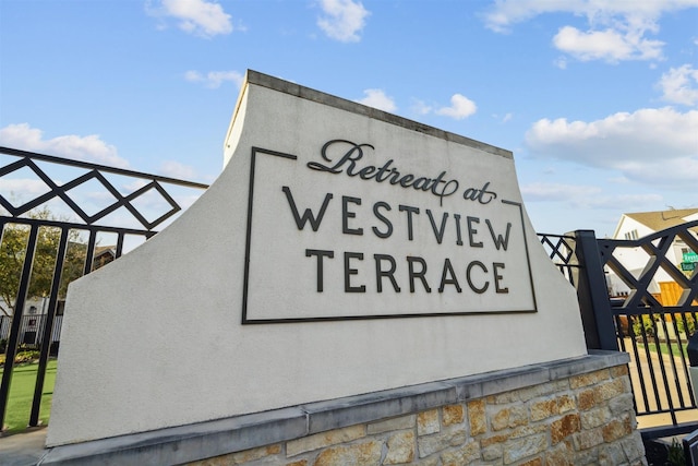 community sign featuring fence