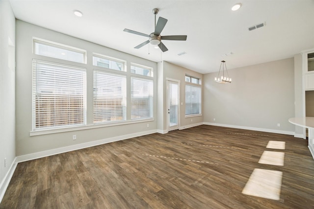 unfurnished living room featuring dark wood-type flooring, visible vents, and baseboards