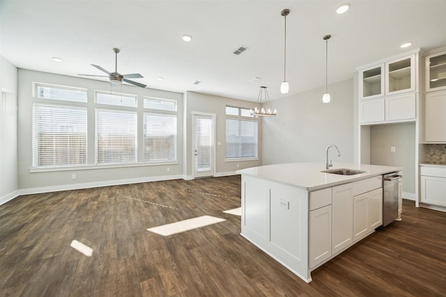 kitchen featuring dark wood-type flooring, a sink, visible vents, open floor plan, and dishwasher