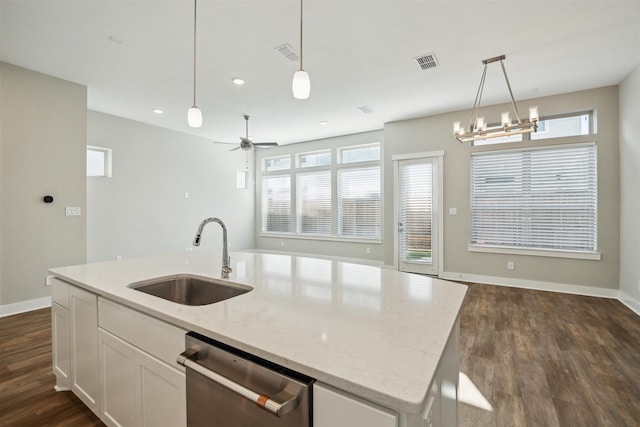 kitchen with dark wood-type flooring, visible vents, a sink, and dishwasher