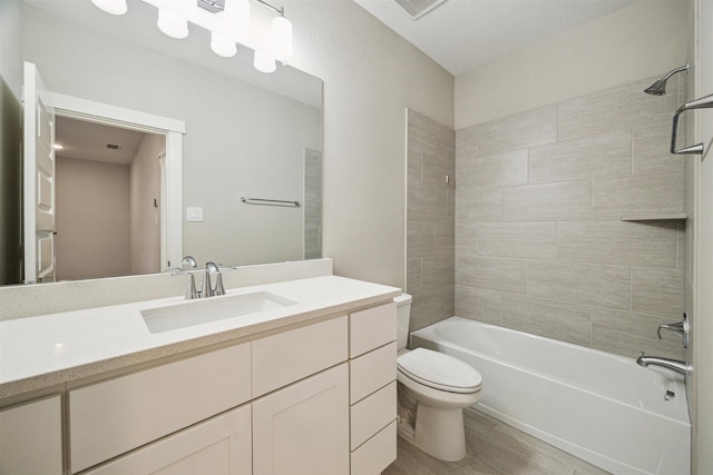 full bath with toilet, shower / bath combination, wood finished floors, visible vents, and vanity