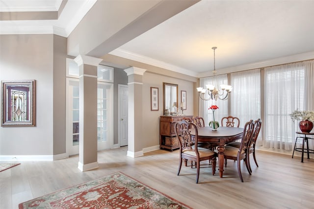 dining space with light wood-style floors, decorative columns, and ornamental molding