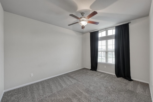 spare room with carpet floors, ceiling fan, and baseboards