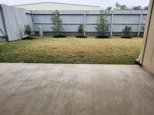 view of yard featuring fence and a patio