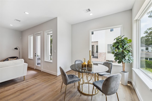 dining space with baseboards, recessed lighting, visible vents, and light wood-style floors