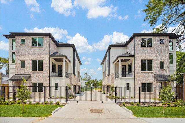 view of front facade with fence and brick siding