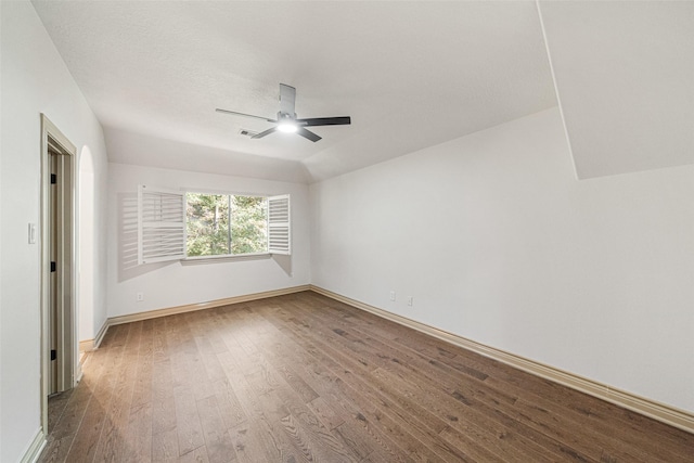 spare room with ceiling fan, wood finished floors, and baseboards