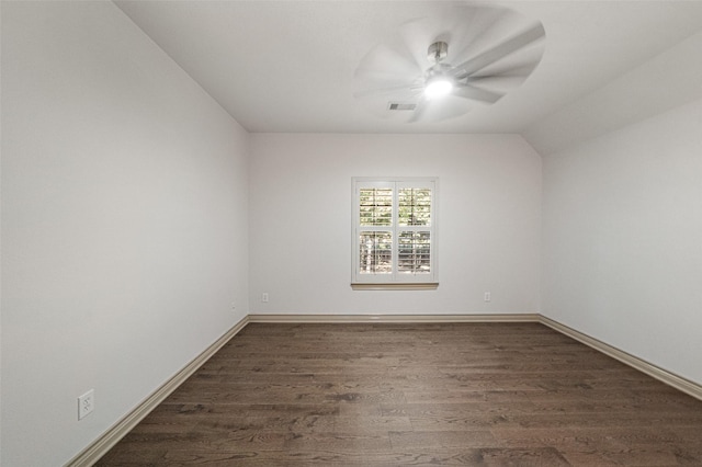 unfurnished room featuring baseboards, visible vents, ceiling fan, wood finished floors, and vaulted ceiling