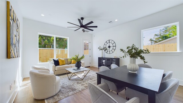 living area with a ceiling fan, baseboards, recessed lighting, and wood finished floors