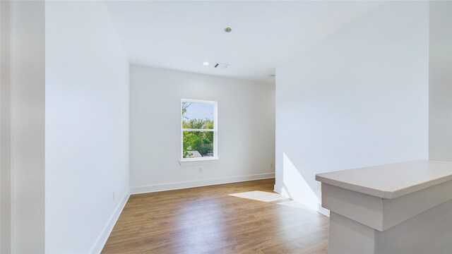 unfurnished room featuring recessed lighting, baseboards, visible vents, and light wood finished floors