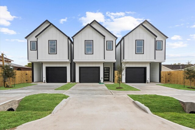 view of front of house featuring board and batten siding, fence, and concrete driveway