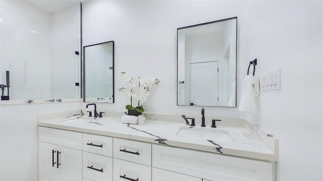 full bathroom featuring double vanity and a sink