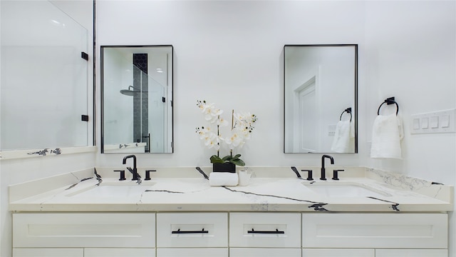 bathroom featuring a sink, a shower stall, and double vanity