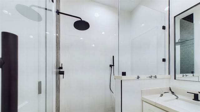 bathroom with a shower stall and vanity