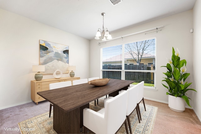 dining space with a chandelier, baseboards, a wealth of natural light, and light colored carpet