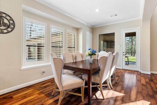 dining room featuring dark wood-type flooring, visible vents, and baseboards