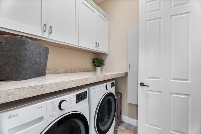 laundry area with washing machine and dryer, cabinet space, and baseboards