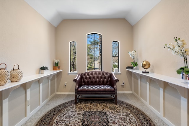 sitting room with lofted ceiling, carpet floors, and baseboards