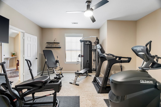 exercise room featuring baseboards, visible vents, and a ceiling fan