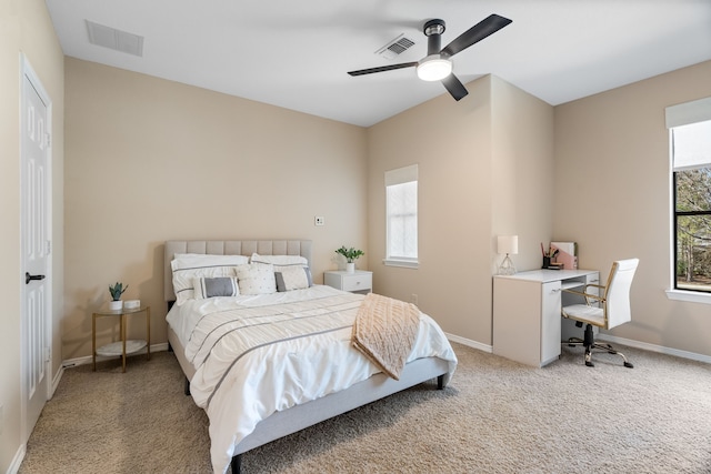 bedroom with baseboards, visible vents, and light colored carpet