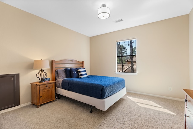 bedroom with light colored carpet, visible vents, and baseboards