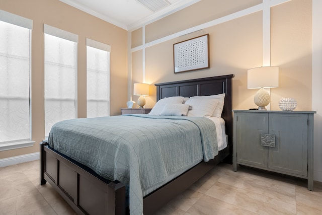 bedroom with baseboards and crown molding