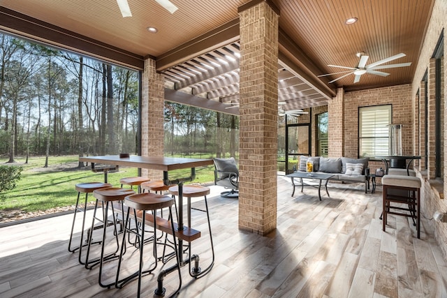 view of patio / terrace with outdoor lounge area, ceiling fan, and a pergola