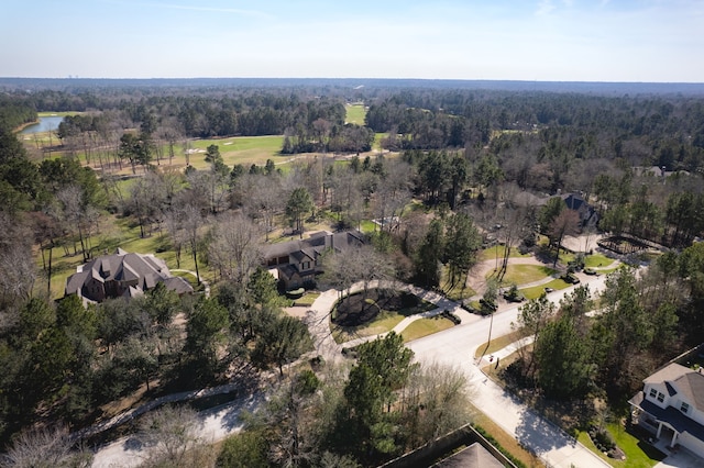 birds eye view of property featuring a wooded view