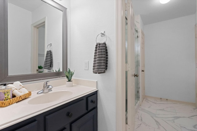 full bathroom featuring a stall shower, marble finish floor, vanity, and baseboards