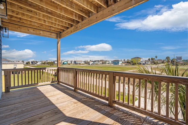 wooden deck with a lawn and a residential view