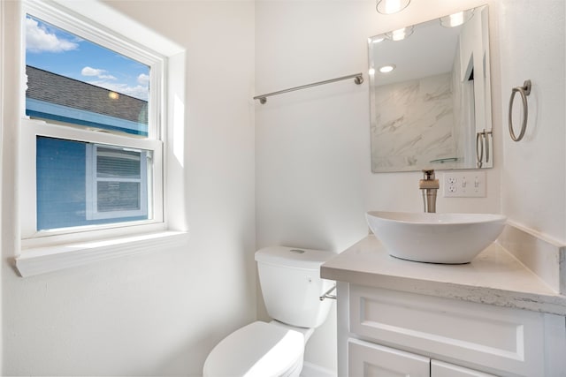 bathroom with toilet and vanity