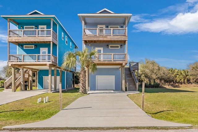 coastal inspired home with a balcony, covered porch, a garage, stairs, and a front lawn