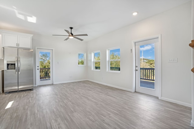 unfurnished living room featuring recessed lighting, light wood-type flooring, a ceiling fan, and baseboards